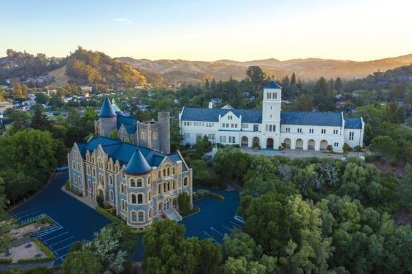 Marin campus buildings in aerial photo surrounded by green trees